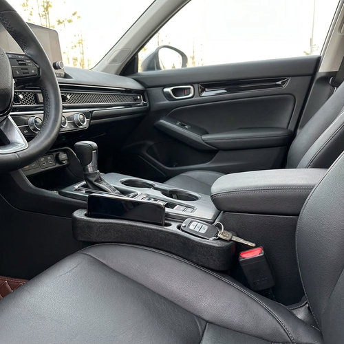 Car seat gap filler strip installed in modern car interior — product photo